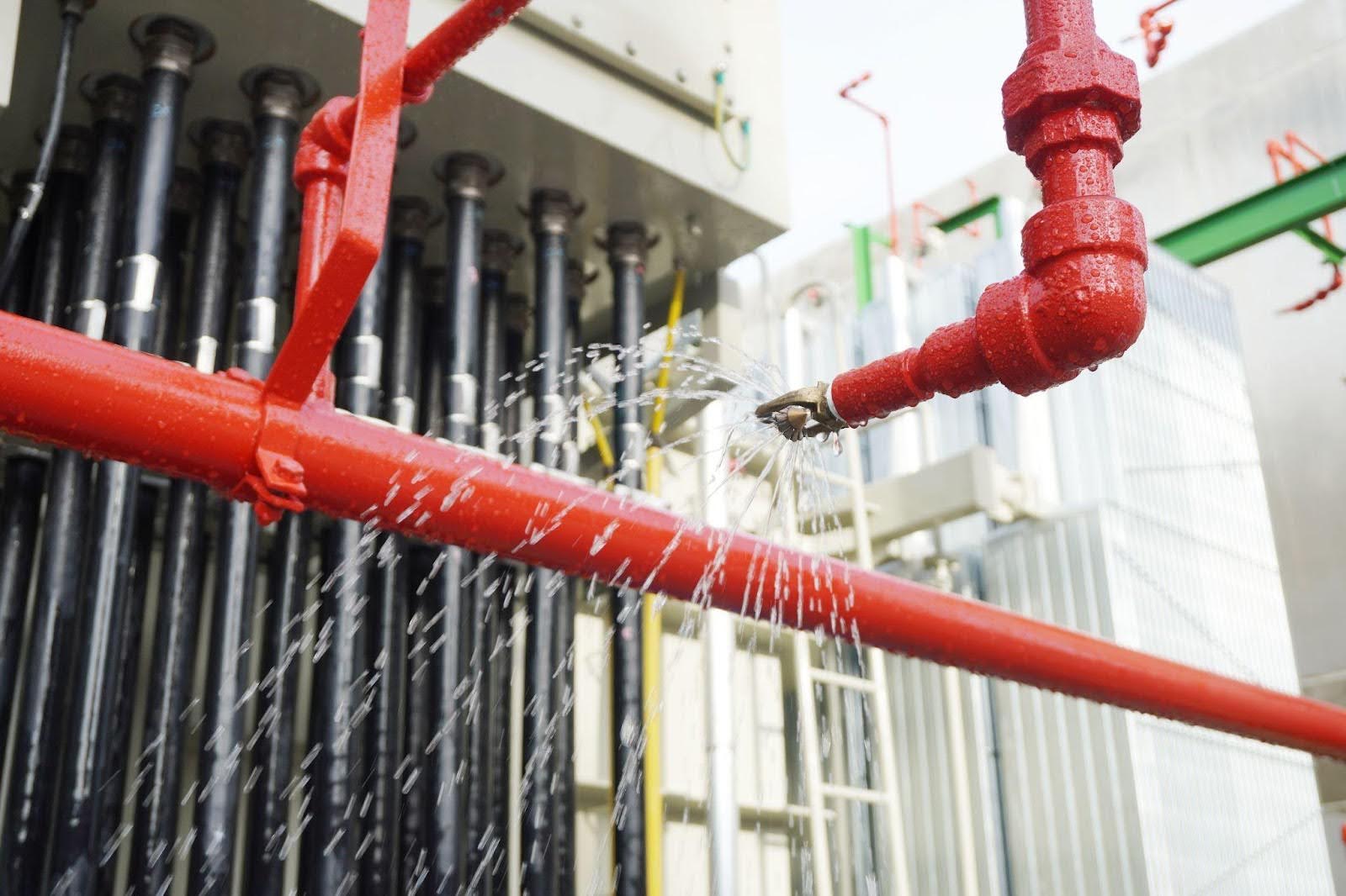 A pipe system with red and white pipes and a prominent red valve