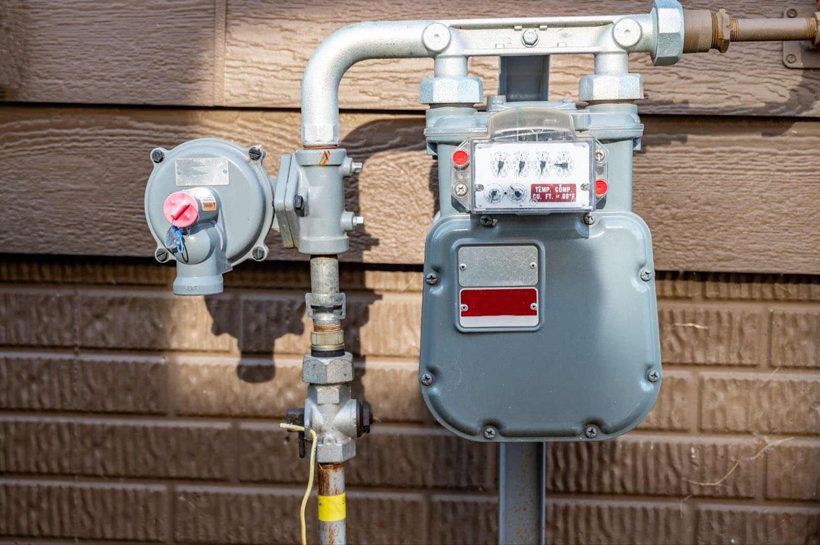 A close-up of a wall-installed meter and valve, emphasizing their operational features