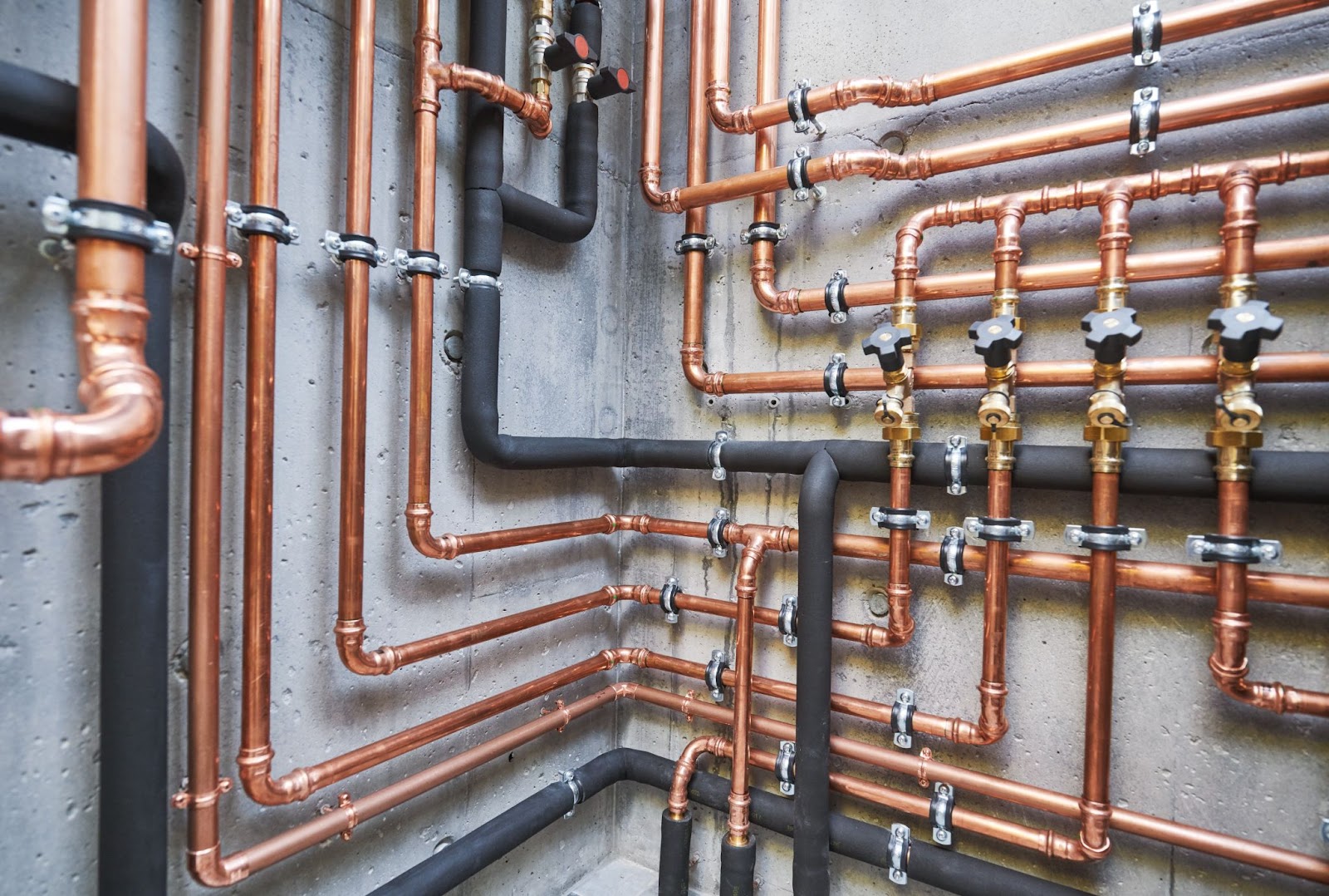 Copper pipes and valves in a room. Secure plumbing, plumbing maintenance, plumbing system.