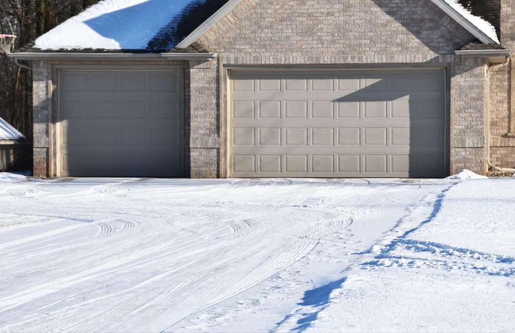 A snowy driveway in Utah featuring a snow melt system designed to efficiently remove ice and snow for safe access.