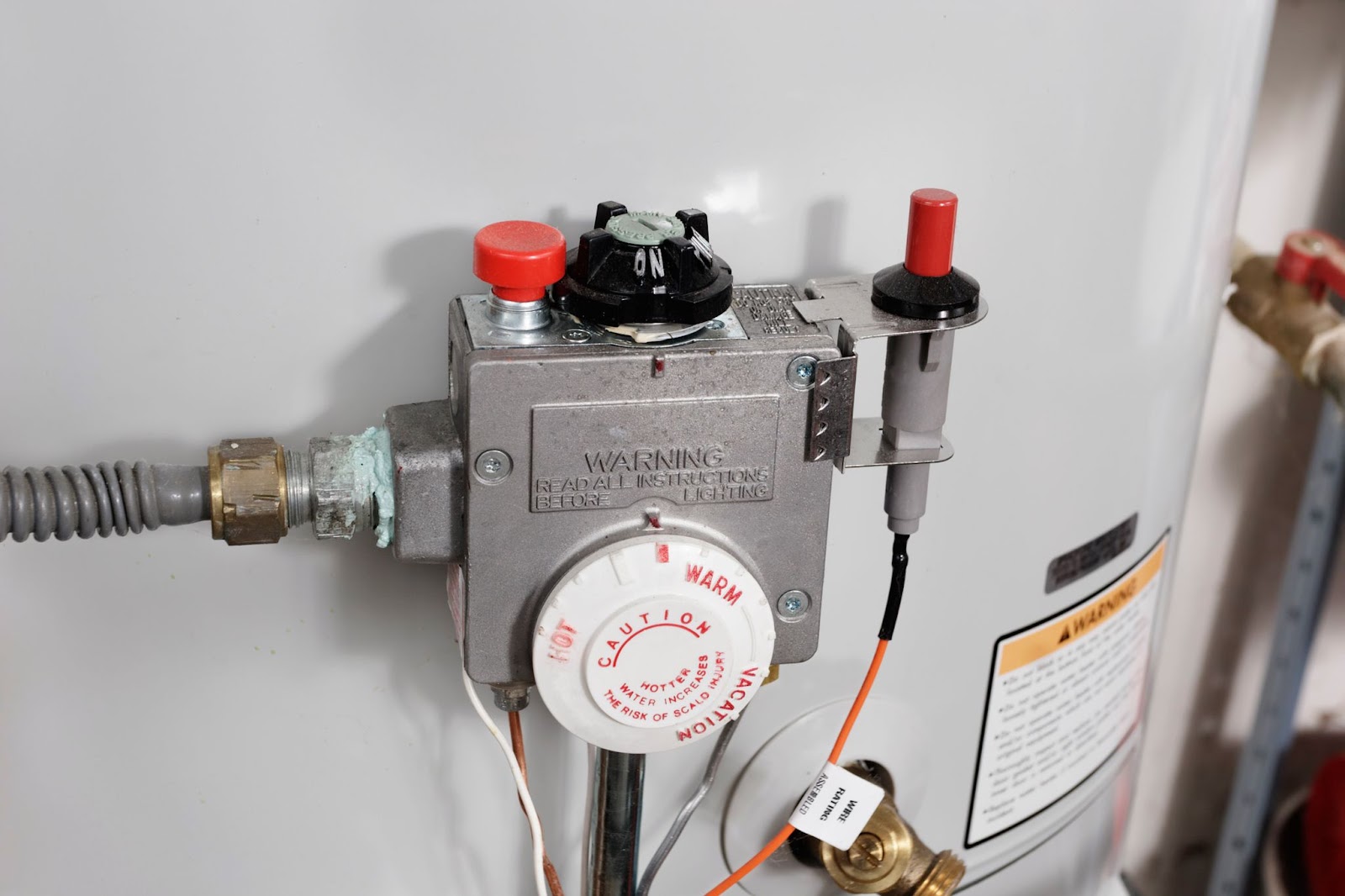 A water heater featuring a thermostat and valve, symbolizing professional plumbing services for water heater repair.