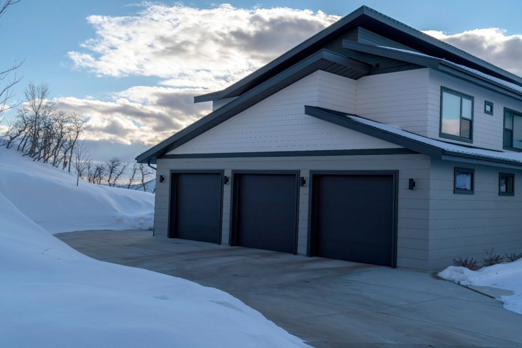 Snow-covered driveway in Utah with a snow melt system, showcasing effective plumbing for ice and snow removal.