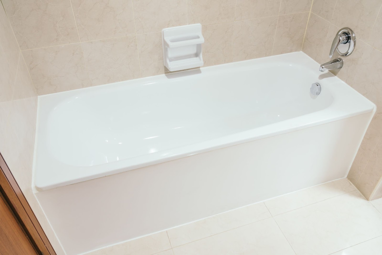 A white bathtub in a bathroom, highlighting common issues like cracks or leaks that may require a professional plumber,s attention.